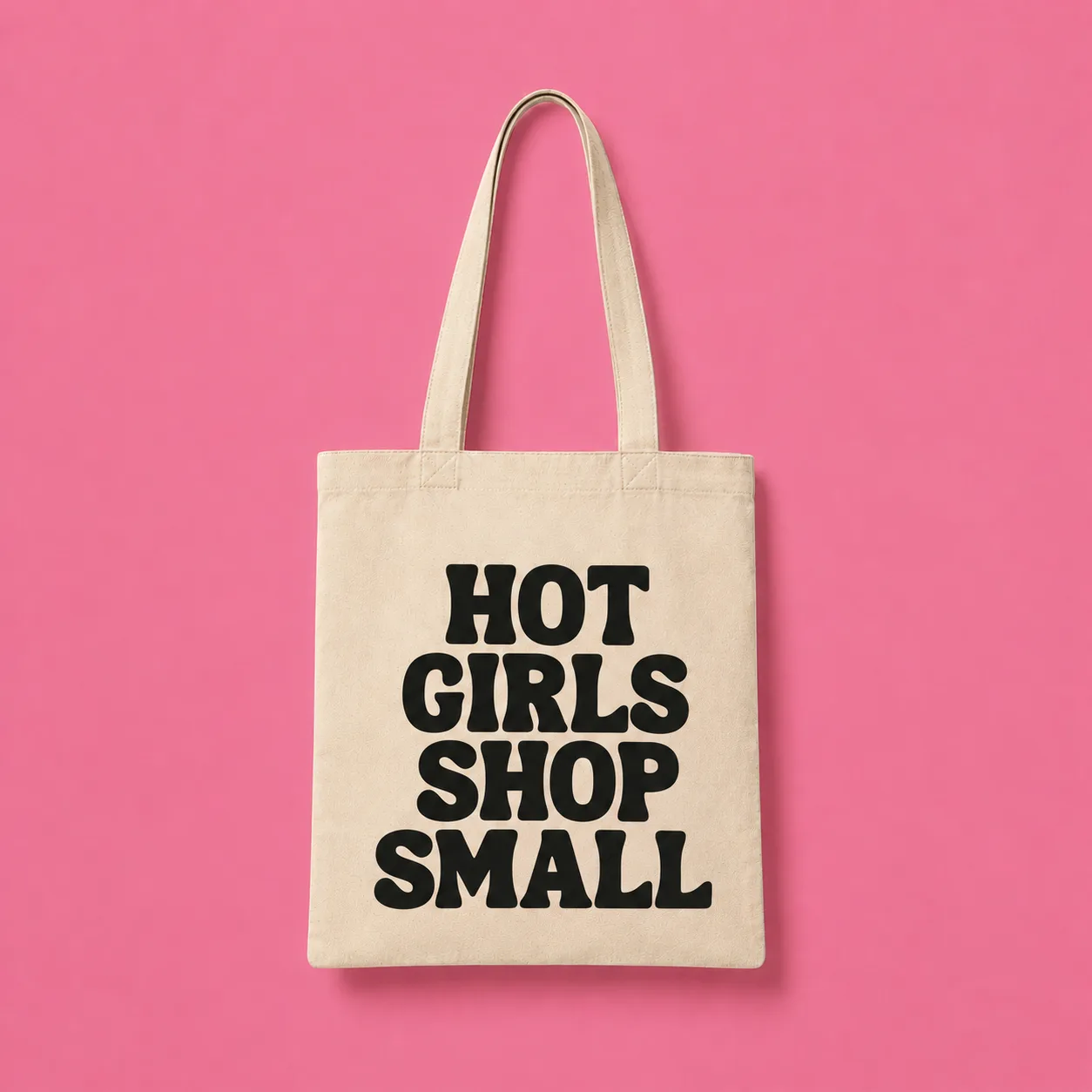 Cream canvas tote reading Hot Girls Shop Small on a pink background
